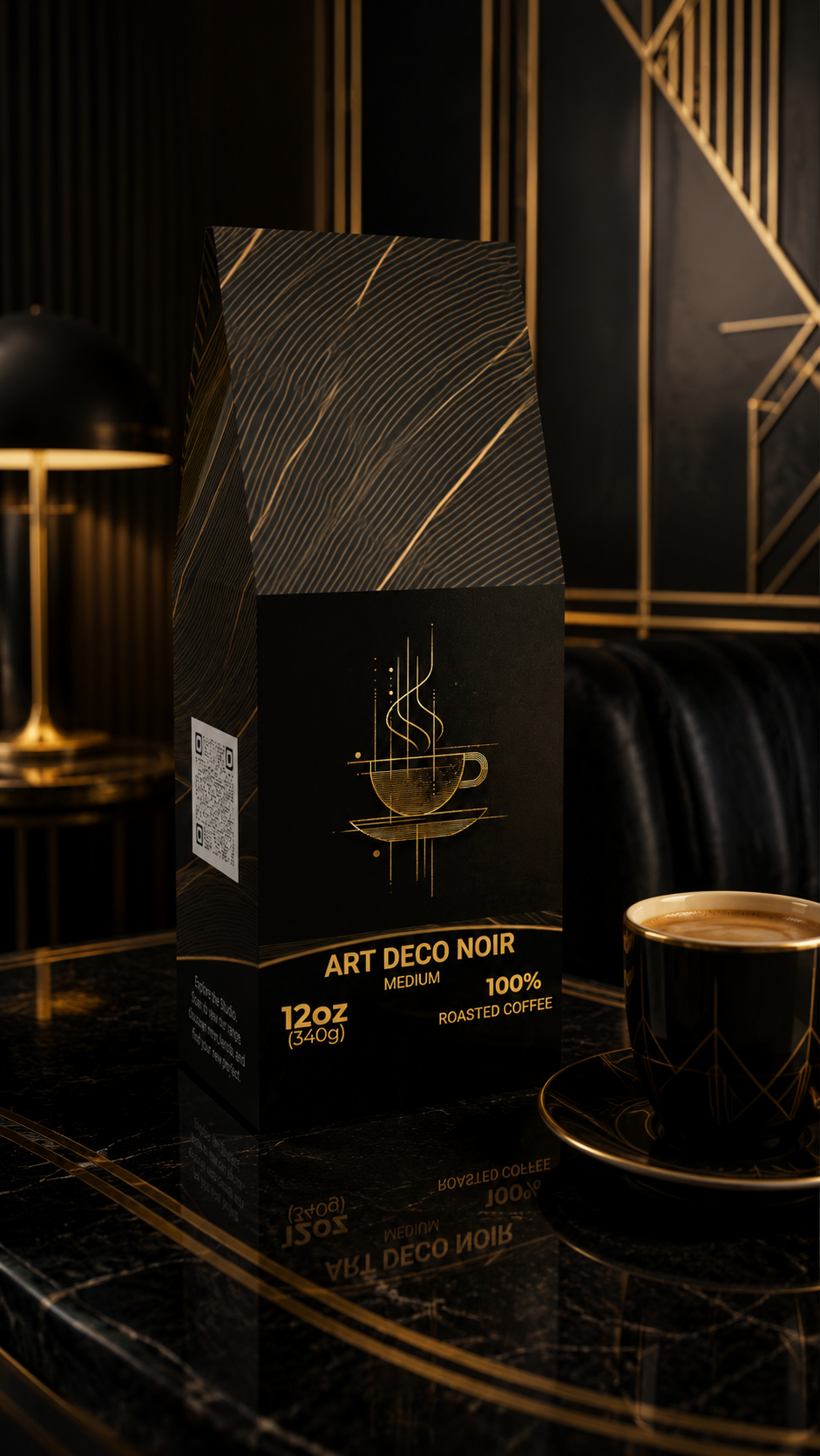A 12oz bag of Art Deco Noir Medium Roasted Coffee sits on a polished black marble table next to a matching black coffee cup and saucer, set against a luxurious dark background with gold accents.