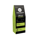 A custom-designed coffee bag packaging mockup on a solid white background. The bag is black with a bright lime green side panel and a green label, featuring placeholder text for a coffee brand.