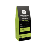 A custom-designed coffee bag packaging mockup on a solid white background. The bag is black with a bright lime green side panel and a green label, featuring placeholder text for a coffee brand.