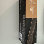 A tall rectangular product box standing upright against a plain light background. The box design is split horizontally: the top half is warm tan/caramel with white 'DESIGN FUEL' text and a small line-art logo, and the bottom half is black with thin warm brown diagonal lines.