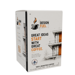 A box of Design Fuel 100% roasted coffee, featuring a white packaging design with black text, orange accents, and architectural line drawings.