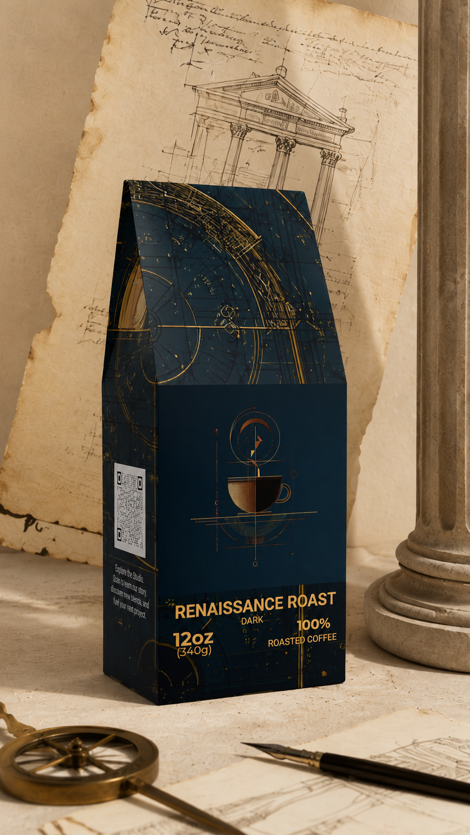 A dark navy coffee bag labeled 'RENAISSANCE ROAST' stands on a tabletop with vintage props, including an aged paper sketchbook, a column base, and a brass compass. The package design features gold celestial line art and text indicating 100% roasted coffee and 12oz size.